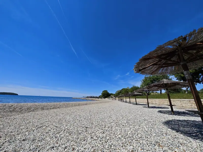 Fuente Beach with straw parasols