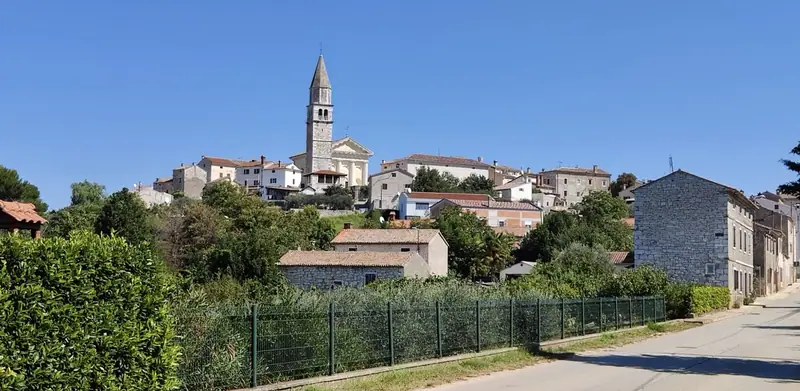 Istrian village with church tower on a hillside