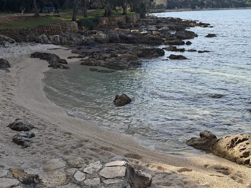 Small bathing bay with rocks and pebbles