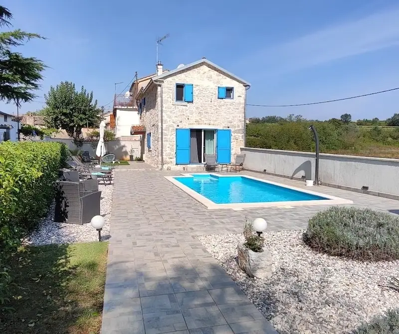 Stone slab path along the pool to the house