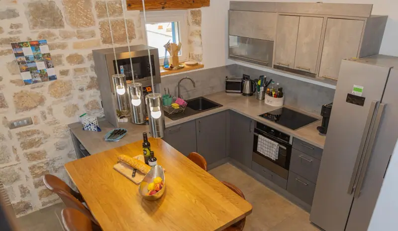 Kitchen with dining counter and side-by-side fridge