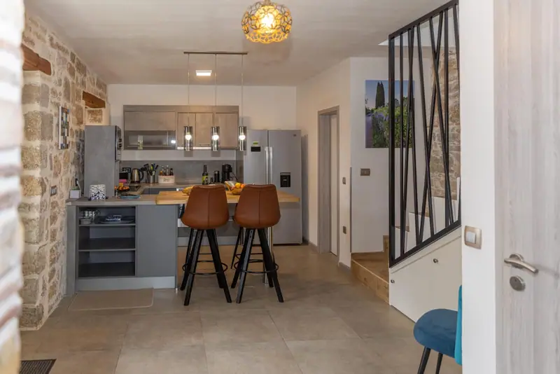 Kitchen with bar stools at the dining counter