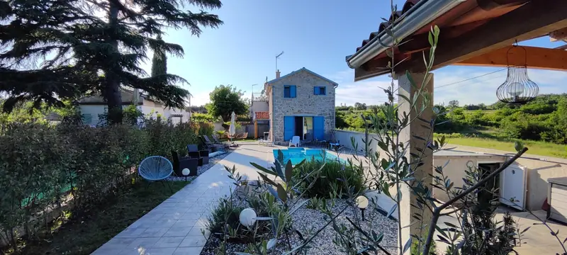 Garden of Villa Allegra with pool, outdoor seating area and stone house