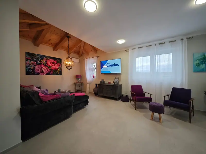 Living area with sofa, armchairs and TV