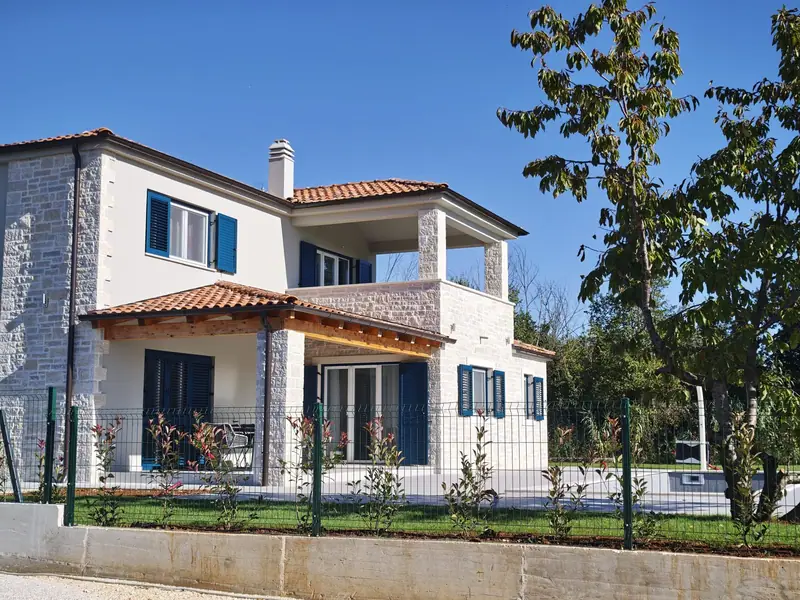 View of the house with garden and olive tree