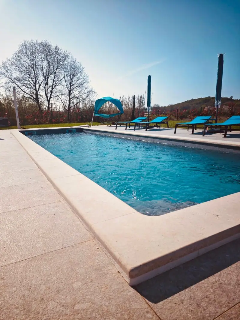 Long pool with sun loungers along the edge