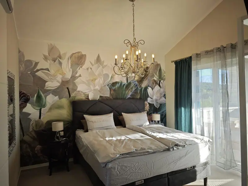 Bedroom with chandelier and floral wallpaper