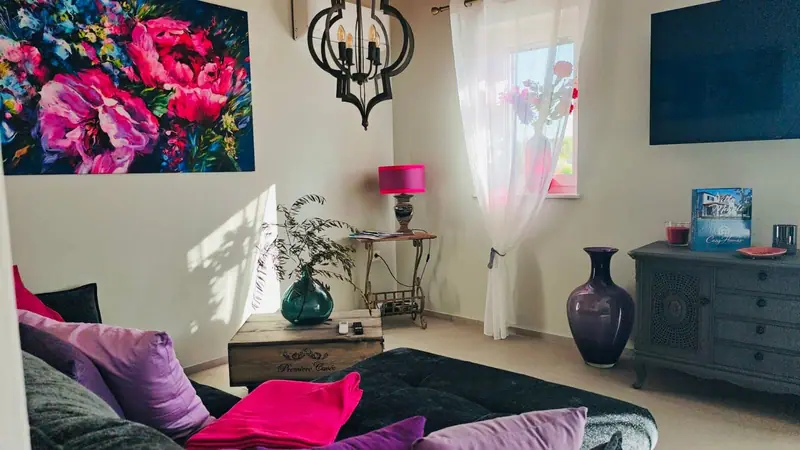 Living room with corner sofa and large flower painting
