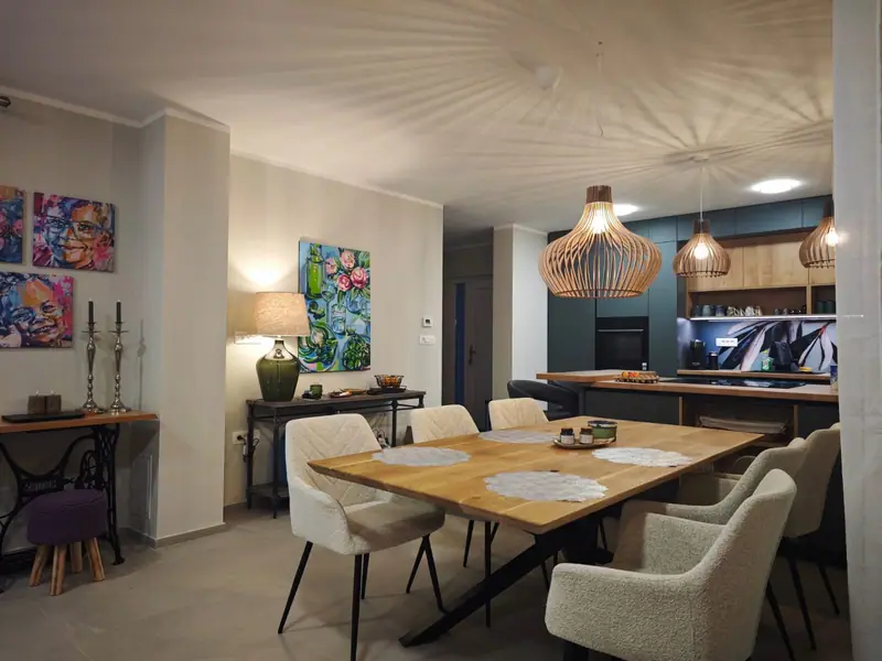 Dining area with wooden table in front of the kitchen